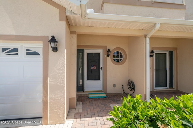 5201 Ocean Beach Blvd Unit 4, Cocoa Beach, FL 32931 - doorway to property featuring stucco siding and a garage