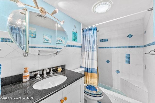 4800 Ocean Beach Blvd Unit 218, Cocoa Beach, FL 32931 - bathroom featuring vanity, tiled shower, and tile walls