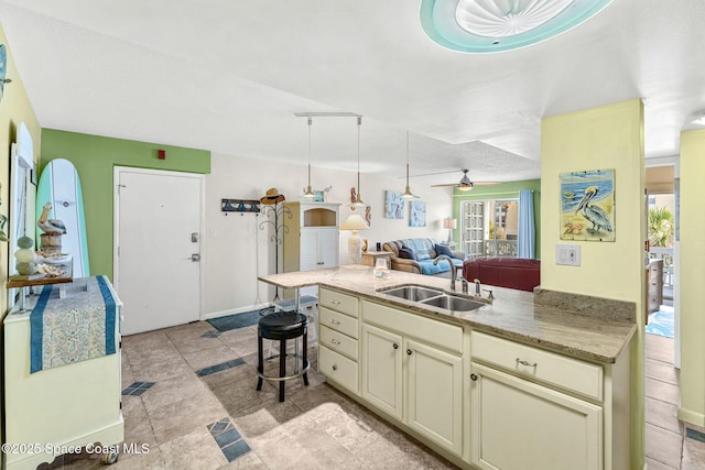 4800 Ocean Beach Blvd Unit 218, Cocoa Beach, FL 32931 - kitchen featuring open floor plan, plenty of natural light, cream cabinetry, and a ceiling fan