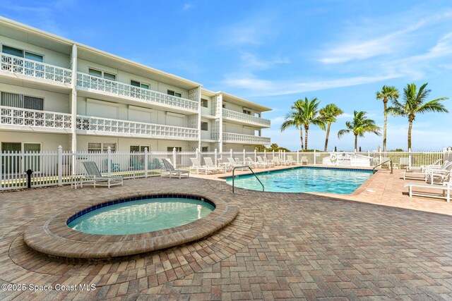 4800 Ocean Beach Blvd Unit 218, Cocoa Beach, FL 32931 - community pool with a patio and a community hot tub