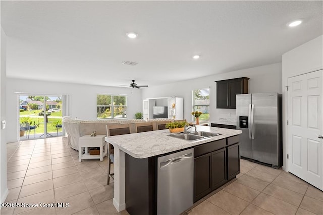 1093 Wabash Rd SE, Palm Bay, FL 32909 - kitchen featuring appliances with stainless steel finishes, a sink, light countertops, healthy amount of natural light, and recessed lighting