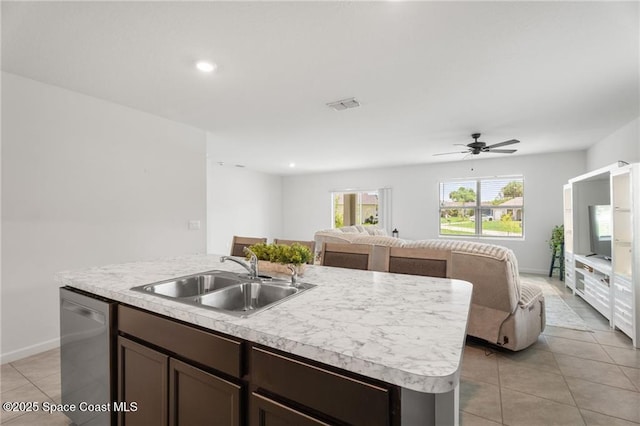 1093 Wabash Rd SE, Palm Bay, FL 32909 - kitchen with stainless steel dishwasher, a sink, open floor plan, light countertops, and light tile patterned floors