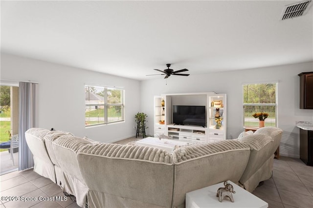 1093 Wabash Rd SE, Palm Bay, FL 32909 - living room featuring light tile patterned floors, plenty of natural light, and ceiling fan