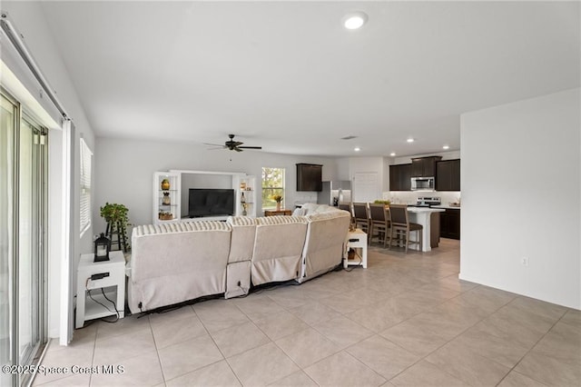1093 Wabash Rd SE, Palm Bay, FL 32909 - living area featuring ceiling fan, light tile patterned floors, and recessed lighting