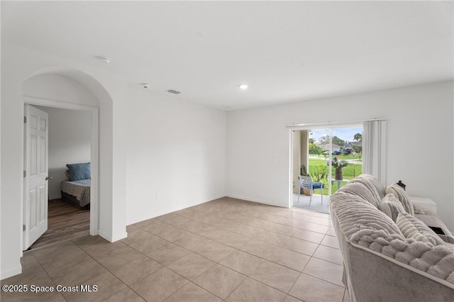 1093 Wabash Rd SE, Palm Bay, FL 32909 - living area with light tile patterned floors, recessed lighting, and arched walkways
