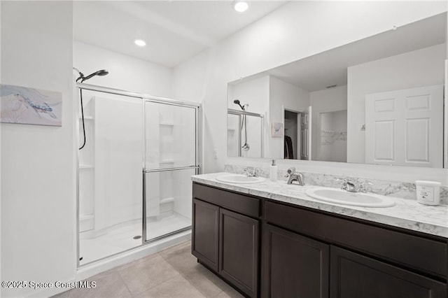 1093 Wabash Rd SE, Palm Bay, FL 32909 - bathroom featuring a shower stall, a spacious closet, double vanity, and tile patterned flooring