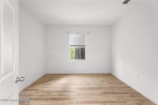 1093 Wabash Rd SE, Palm Bay, FL 32909 - spare room featuring wood finished floors and baseboards