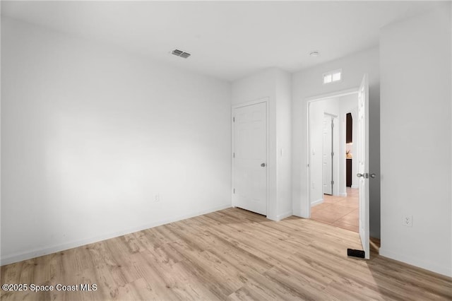 1093 Wabash Rd SE, Palm Bay, FL 32909 - spare room featuring light wood-style flooring and baseboards