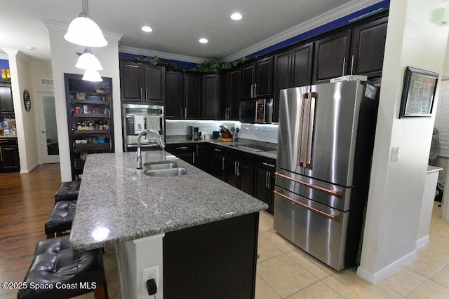 1757 Attilburgh Blvd, Melbourne, FL 32904 - kitchen featuring stainless steel appliances, ornamental molding, light stone counters, a breakfast bar area, and dark cabinetry
