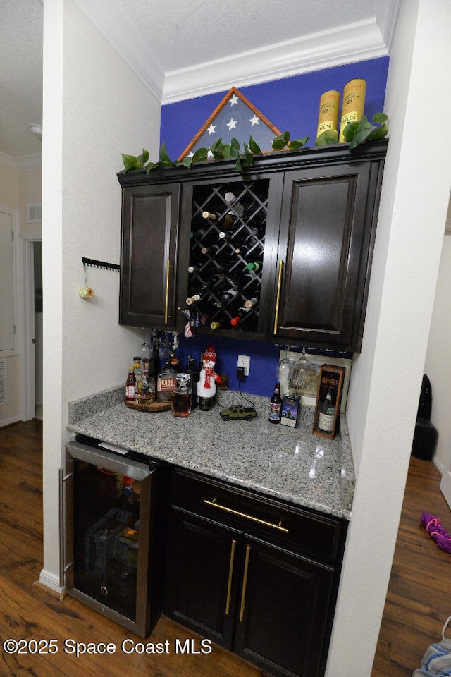 1757 Attilburgh Blvd, Melbourne, FL 32904 - indoor dry bar with beverage cooler, ornamental molding, and wood finished floors