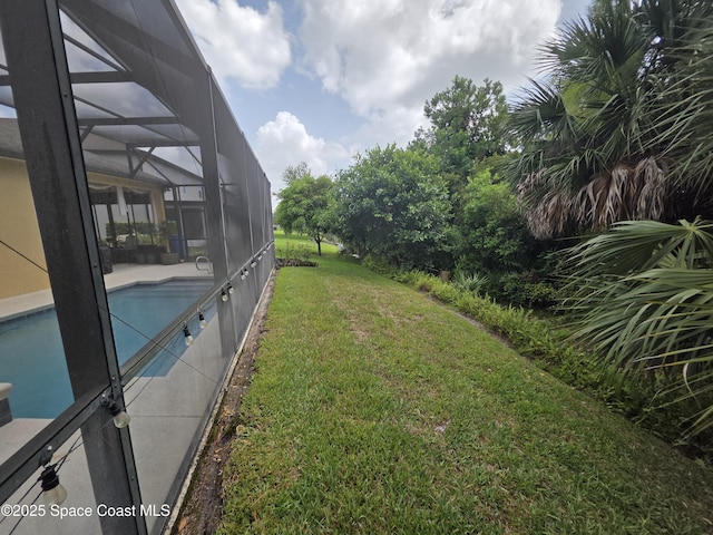 1757 Attilburgh Blvd, Melbourne, FL 32904 - view of grassy yard with an outdoor pool, glass enclosure, and a patio area