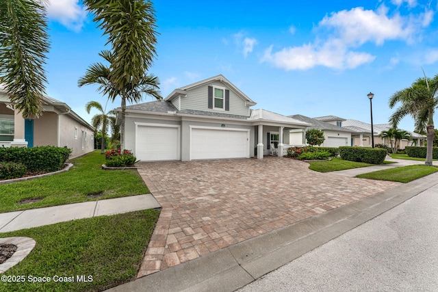 1649 Tullagee Ave, Melbourne, FL 32940 - traditional home featuring a front yard, driveway, a garage, and stucco siding