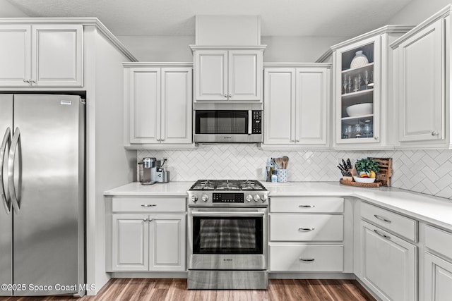 1649 Tullagee Ave, Melbourne, FL 32940 - kitchen with stainless steel appliances, white cabinets, and glass insert cabinets