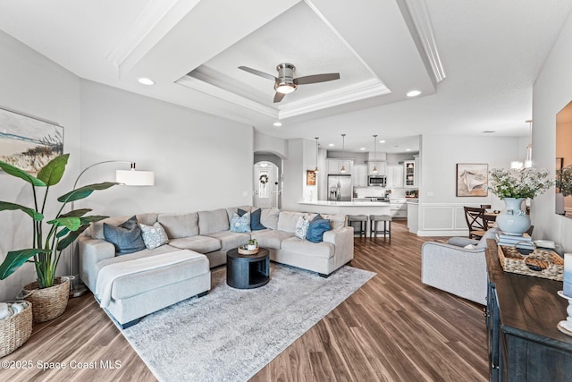 1649 Tullagee Ave, Melbourne, FL 32940 - living area featuring ceiling fan, dark wood-style flooring, a raised ceiling, recessed lighting, and arched walkways