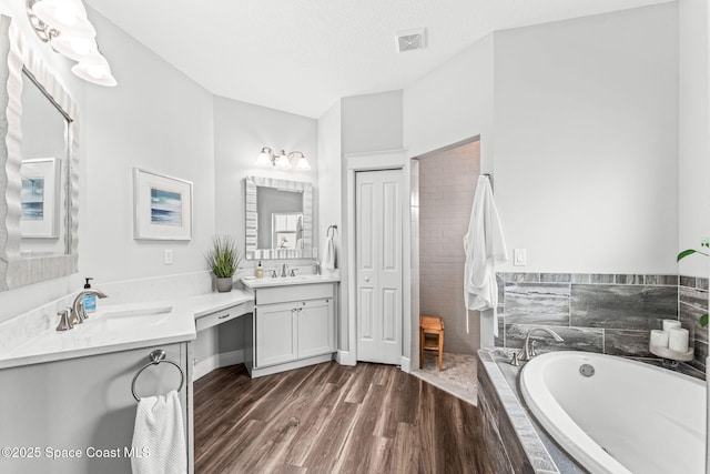 1649 Tullagee Ave, Melbourne, FL 32940 - full bath with vanity, a bath, wood finished floors, and tiled shower
