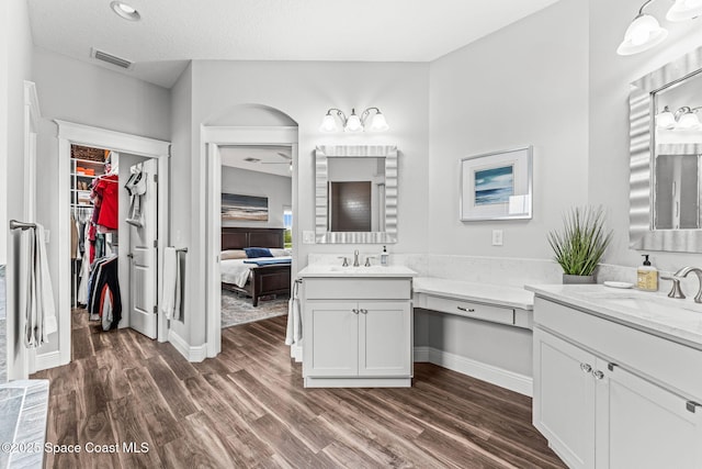 1649 Tullagee Ave, Melbourne, FL 32940 - full bathroom with wood finished floors, two vanities, ensuite bath, and a spacious closet