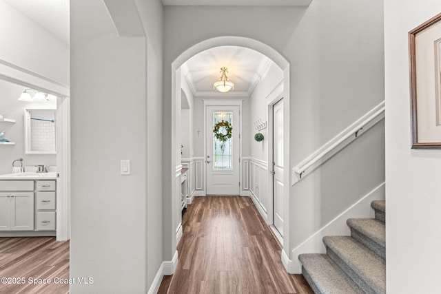 1649 Tullagee Ave, Melbourne, FL 32940 - foyer featuring arched walkways, wood finished floors, stairway, and ornamental molding