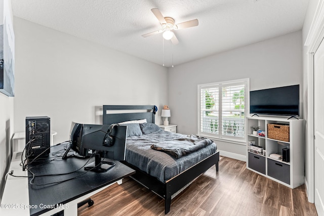 1649 Tullagee Ave, Melbourne, FL 32940 - bedroom with wood finished floors, ceiling fan, and a textured ceiling