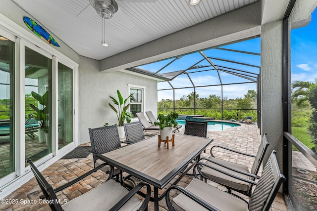 1649 Tullagee Ave, Melbourne, FL 32940 - view of patio / terrace featuring an outdoor pool, a ceiling fan, glass enclosure, outdoor dining area, and a jacuzzi