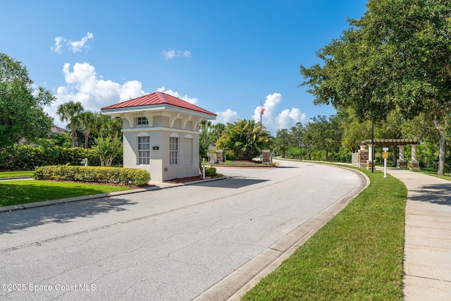 1649 Tullagee Ave, Melbourne, FL 32940 - view of asphalt street with curbs, sidewalks, and traffic signs