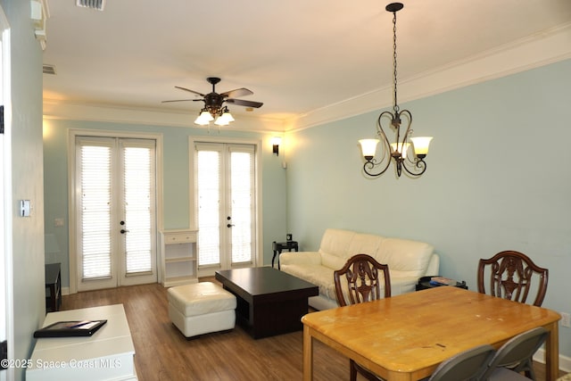 1320 NW 3rd Ave # 238, Gainesville, FL 32608 - dining area with french doors, wood finished floors, ceiling fan, crown molding, and a chandelier