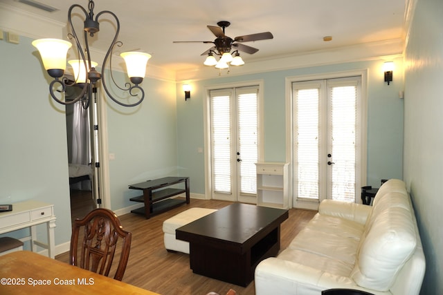 1320 NW 3rd Ave # 238, Gainesville, FL 32608 - living room featuring french doors, ceiling fan, wood finished floors, crown molding, and a chandelier