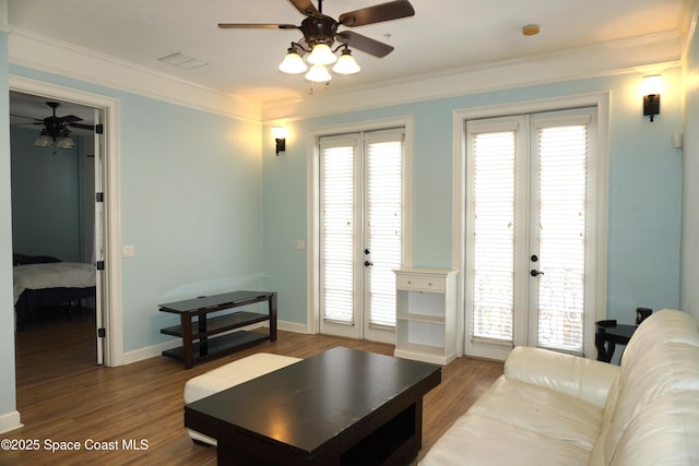 1320 NW 3rd Ave # 238, Gainesville, FL 32608 - living room with french doors, a ceiling fan, wood finished floors, and ornamental molding