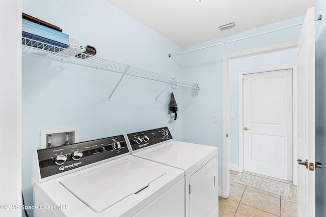 1121 S Orlando Ave, Cocoa Beach, FL 32931 - laundry area featuring independent washer and dryer and light tile patterned flooring