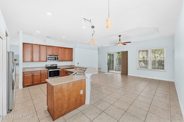 1121 S Orlando Ave, Cocoa Beach, FL 32931 - kitchen featuring appliances with stainless steel finishes, light tile patterned flooring, brown cabinets, a ceiling fan, and recessed lighting