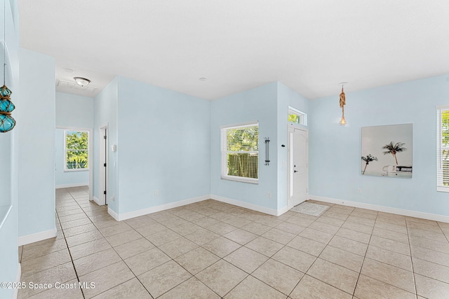 1121 S Orlando Ave, Cocoa Beach, FL 32931 - unfurnished room with light tile patterned floors and plenty of natural light