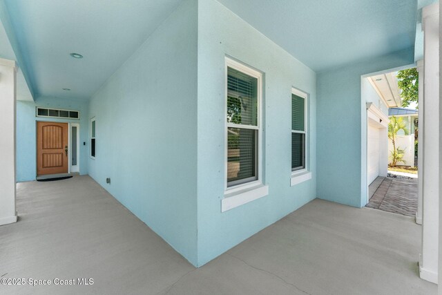 1121 S Orlando Ave, Cocoa Beach, FL 32931 - property entrance with stucco siding and a patio area