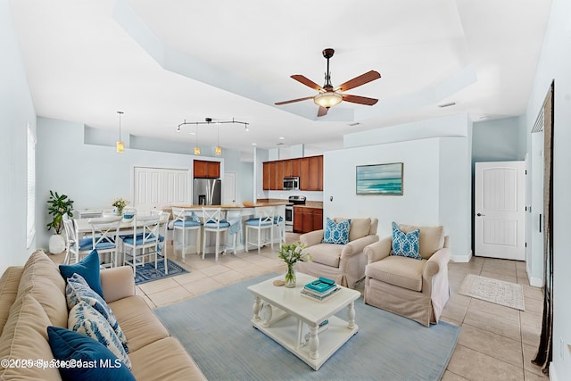 1121 S Orlando Ave, Cocoa Beach, FL 32931 - living room with light tile patterned floors and ceiling fan