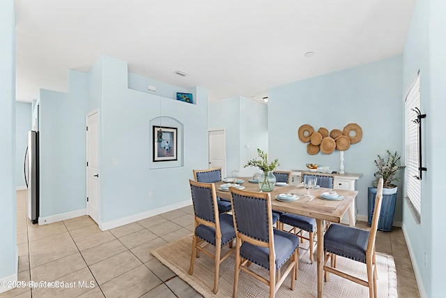 1121 S Orlando Ave, Cocoa Beach, FL 32931 - dining space with light tile patterned floors and baseboards
