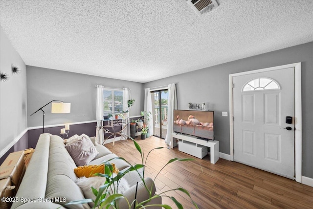 1020 Abada Ct NE Unit 108, Palm Bay, FL 32905 - living room featuring wood finished floors and a textured ceiling