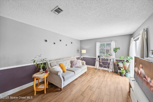 1020 Abada Ct NE Unit 108, Palm Bay, FL 32905 - living area with wood finished floors and a textured ceiling