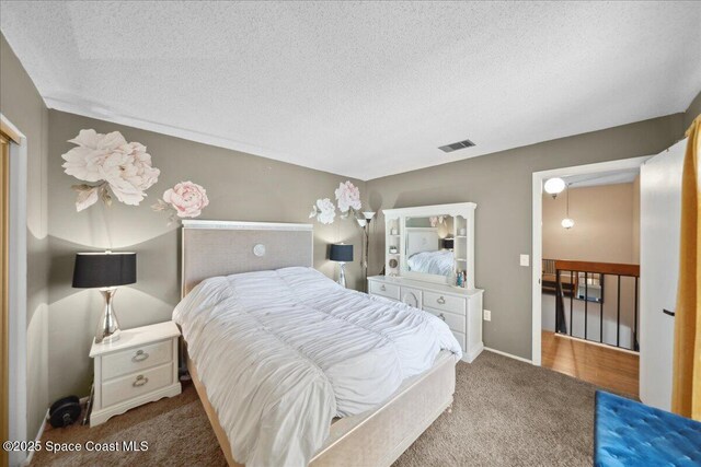 1020 Abada Ct NE Unit 108, Palm Bay, FL 32905 - bedroom with carpet flooring and a textured ceiling