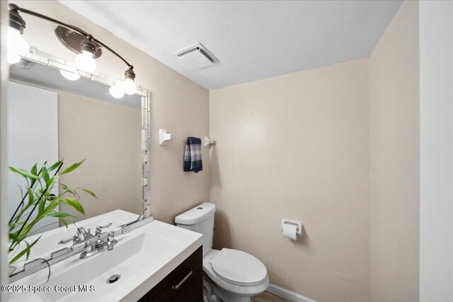 1020 Abada Ct NE Unit 108, Palm Bay, FL 32905 - half bathroom featuring vanity and toilet