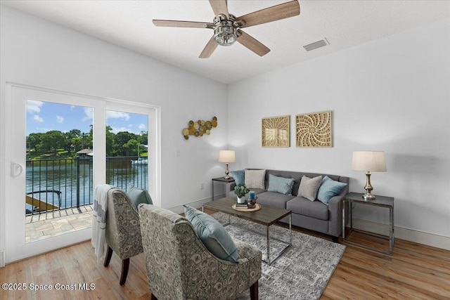 833 Paddleboard Ct, Melbourne, FL 32935 - living room featuring wood finished floors, a ceiling fan, and a water view