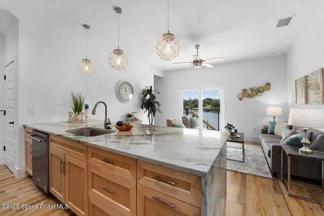833 Paddleboard Ct, Melbourne, FL 32935 - kitchen with dishwasher, light wood-style floors, a ceiling fan, light stone countertops, and open floor plan