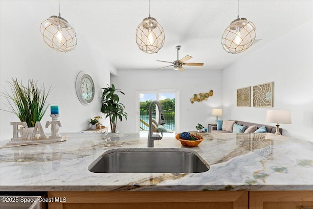 833 Paddleboard Ct, Melbourne, FL 32935 - kitchen featuring open floor plan, light stone countertops, decorative light fixtures, and ceiling fan