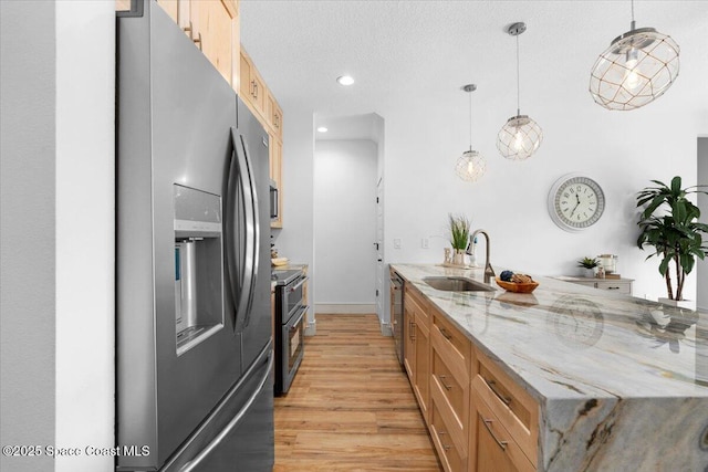 833 Paddleboard Ct, Melbourne, FL 32935 - kitchen featuring appliances with stainless steel finishes, light wood-style floors, recessed lighting, a peninsula, and light stone counters