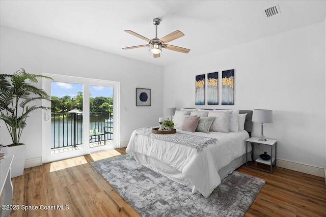 833 Paddleboard Ct, Melbourne, FL 32935 - bedroom with access to outside, wood finished floors, a ceiling fan, and a water view
