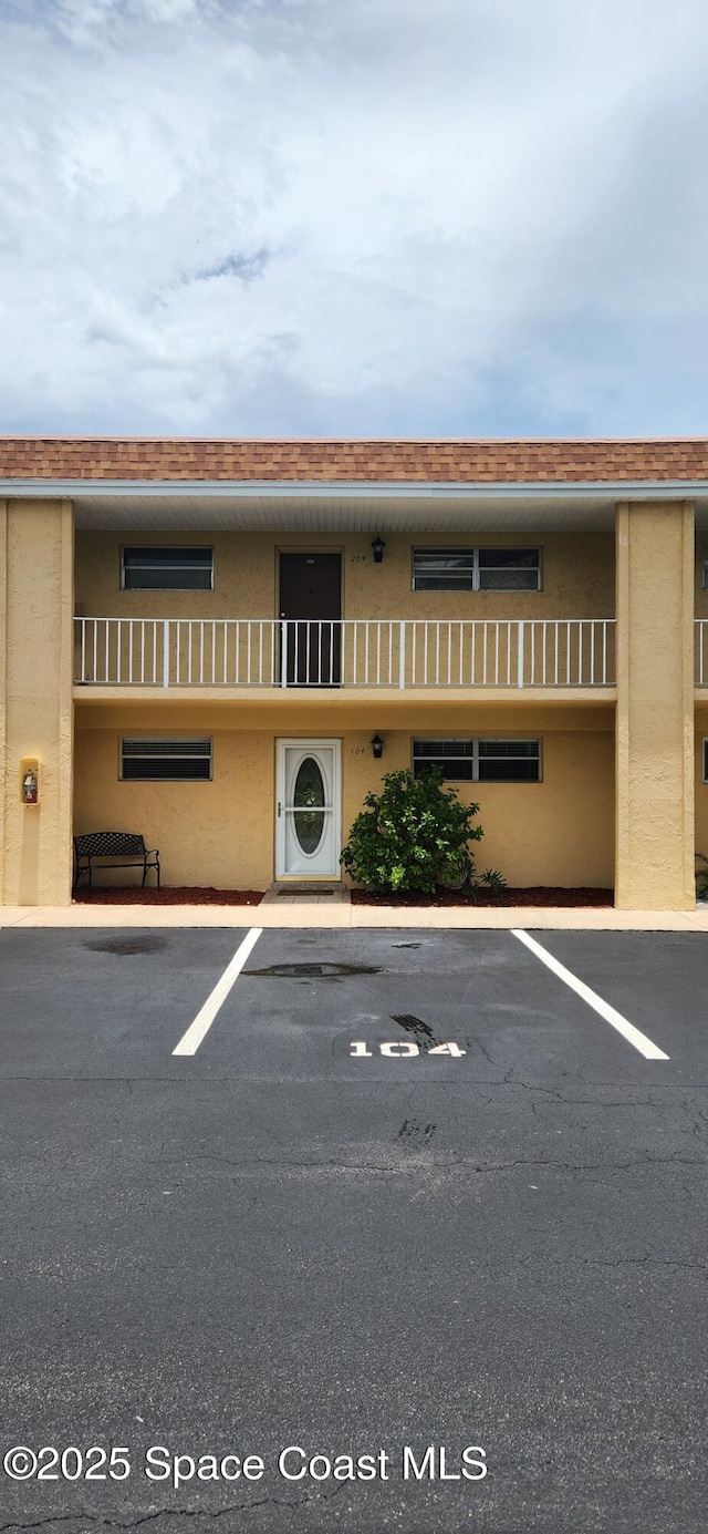 2135 N Courtenay Pkwy Unit 104, Merritt Island, FL 32953 - view of building exterior featuring uncovered parking