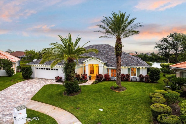 4104 Melrose Ct, Melbourne, FL 32940 - view of front of home with decorative driveway, an attached garage, and a front lawn