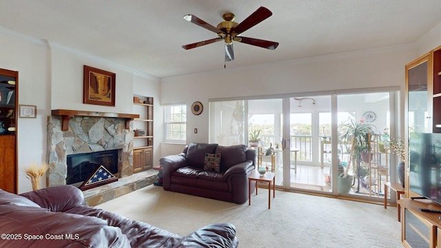 905 N Harbor City Blvd Unit 403, Melbourne, FL 32935 - carpeted living room featuring a ceiling fan, a stone fireplace, and crown molding