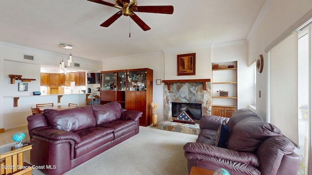 905 N Harbor City Blvd Unit 403, Melbourne, FL 32935 - living room featuring crown molding, ceiling fan, a stone fireplace, and carpet floors