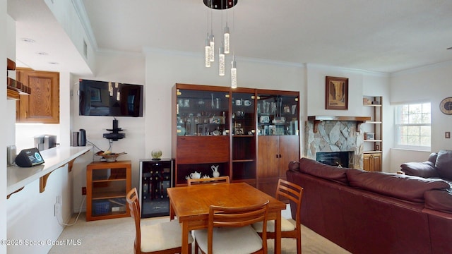 905 N Harbor City Blvd Unit 403, Melbourne, FL 32935 - dining area featuring crown molding, a fireplace, wine cooler, and light carpet