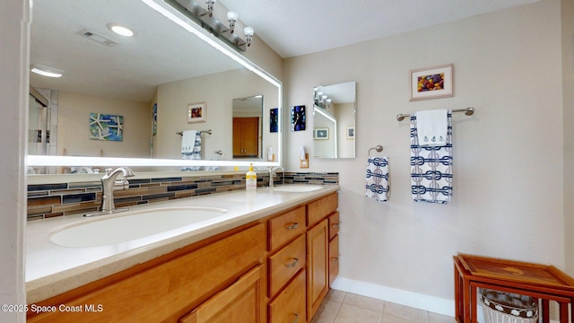 905 N Harbor City Blvd Unit 403, Melbourne, FL 32935 - bathroom featuring double vanity, tasteful backsplash, and tile patterned floors