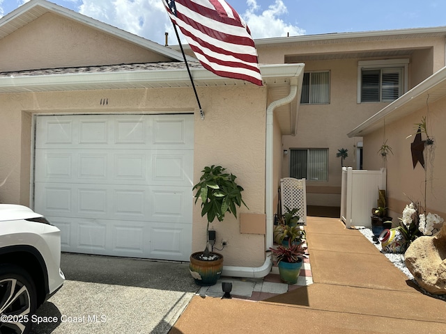111 Plover Ln Unit 3-35, Rockledge, FL 32955 - view of front of home featuring stucco siding and a garage