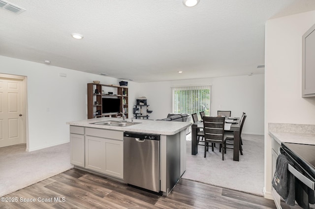 788 Isar Ave NW, Palm Bay, FL 32907 - kitchen featuring dishwasher, open floor plan, light countertops, dark wood finished floors, and a center island with sink